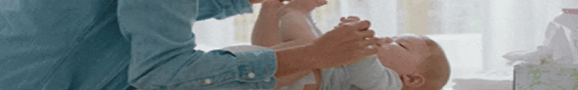 Parent cradling a newborn baby