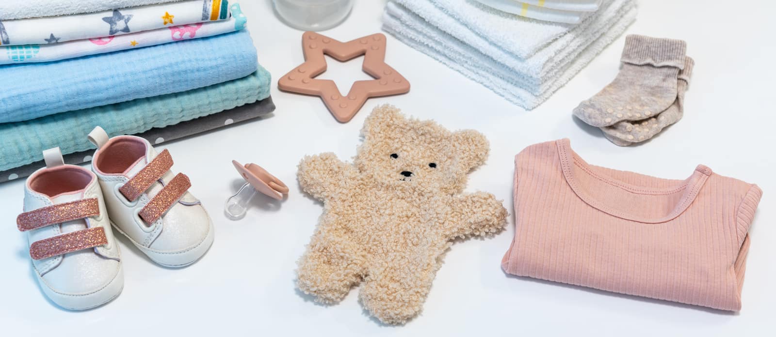 A collection of MeroMomma baby products — bottles, footwear, toys and care essentials