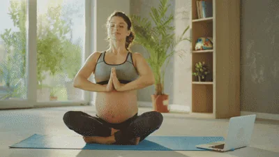 Mother practising gentle prenatal yoga at home